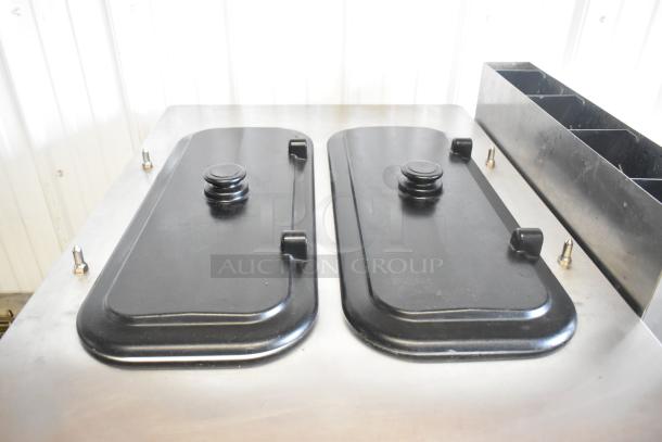 Taylor C723-27 stainless steel countertop soft serve machine; features dual flavor with twist option, visible black covers.