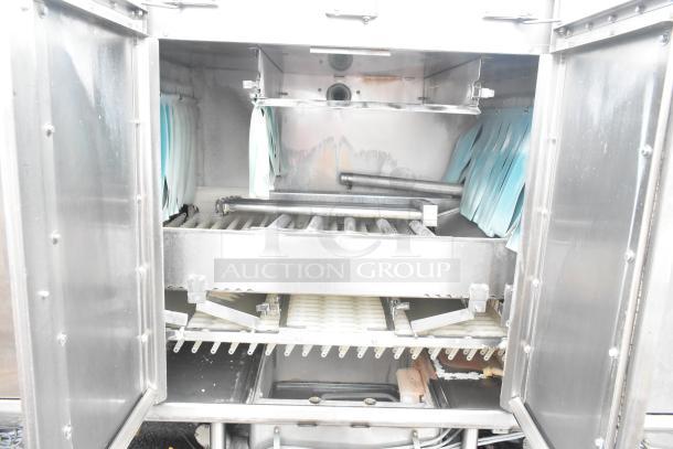 Hobart FT900 commercial flight dishwasher, stainless steel interior, 480 volts, 3 phase, used condition showing interior components.