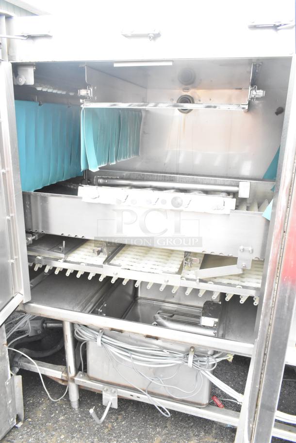 Hobart FT900 commercial flight style dishwasher, 480V, 3-phase, stainless steel, internal racks visible, excellent condition.