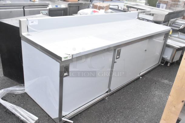 Brand new Regency 600EBTB3096D 30" x 96" stainless steel enclosed table, sliding doors, adjustable midshelf, 6" backsplash.