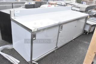 Brand new Regency 600EBTB3096D 30" x 96" stainless steel enclosed table, sliding doors, adjustable midshelf, 6" backsplash.