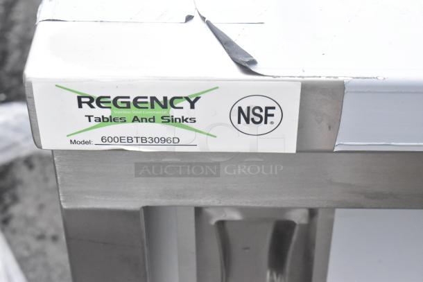 BRAND NEW SCRATCH AND DENT Regency 30"x96" stainless steel table with enclosed base, adjustable midshelf, and 6" backsplash. Model: 600EBTB3096D, NSF certified.