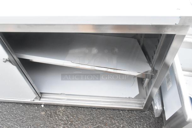 Regency 600EBTB3096D stainless steel sliding door table, 96"x30", with 6" backsplash, adjustable midshelf, scratch and dent.