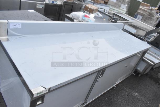 Brand new Regency 30"x96" stainless steel table, model 600EBTB3096D, with enclosed base, sliding doors, midshelf, and backsplash.