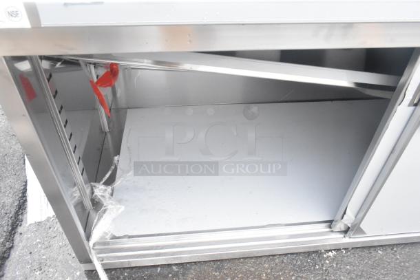 Brand new Regency 30"x96" stainless steel table with scratches. Enclosed base, sliding doors, adjustable midshelf, 6" backsplash.