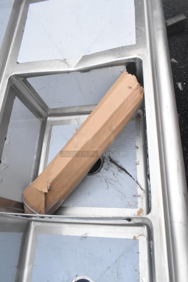 Brand new scratch and dent Advance Tabco FE-3-1812-18RL, 90" stainless steel commercial sink with three compartments and two drainboards.
