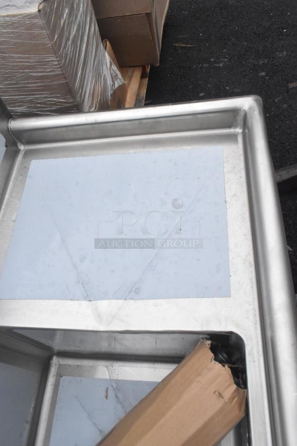 Advance Tabco FE-3-1812-18RL stainless steel sink, three compartments, two drainboards, brand new with visible scratches and dents.