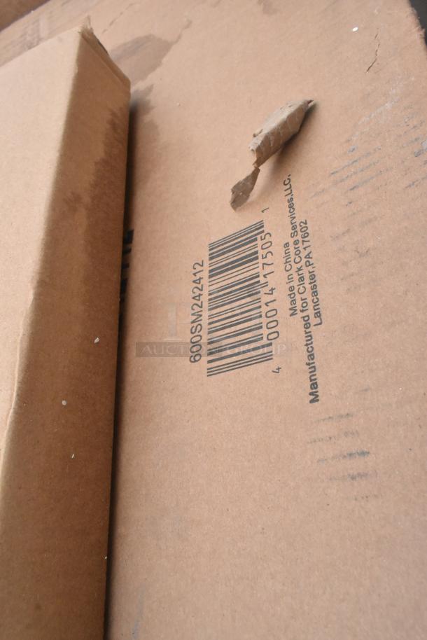 Cardboard box with barcode 600SM242412, showing slight damage. Marking: "Manufactured for Clark Core Services, LLC."