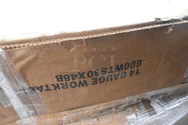 Cardboard box labeled "14 Gauge Worktable 60W T530X48B," showing signs of wear. Contains new scratch and dent items.
