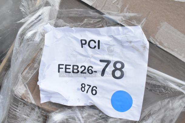 Image displaying a torn white label reading "PCI FEB26-78 876" with a blue dot on plastic-wrapped items.
