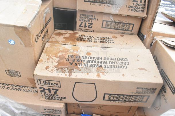Boxes labeled "Libbey 217" indicating stemless glassware. Visible scratches and dents on boxes.