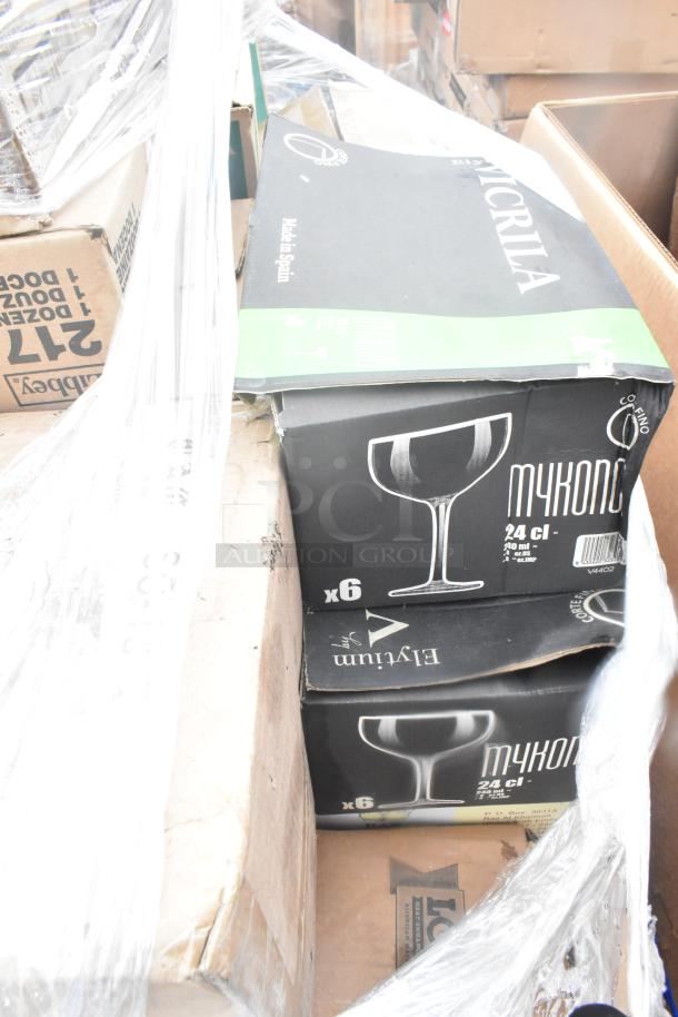Boxes of Mykonos glassware, marked "Made in Spain," containing 6 pieces each. Items are brand new, stored in original packaging.