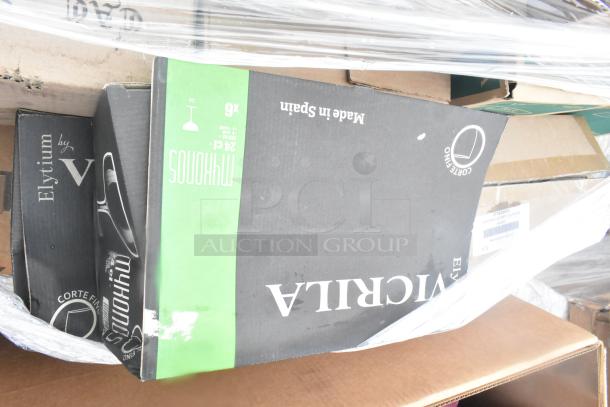Box of scratch and dent glassware labeled "VICRILA" and "Elytium by V," made in Spain, showing packaging wear.