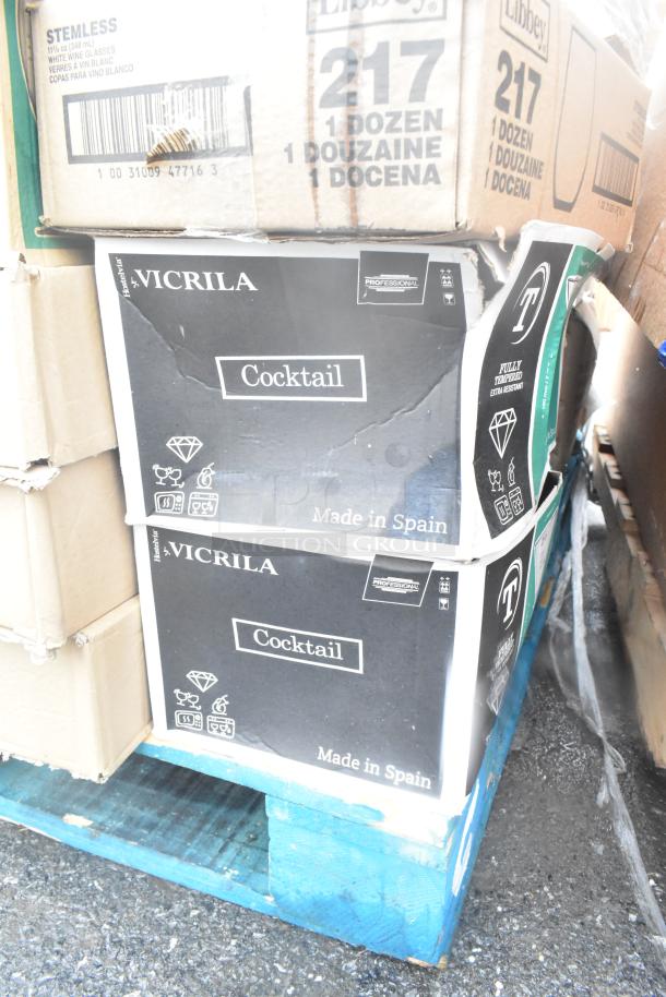 Boxes of Vicrila cocktail glasses, "Made in Spain" marked, stacked on a pallet; new, scratch and dent items.