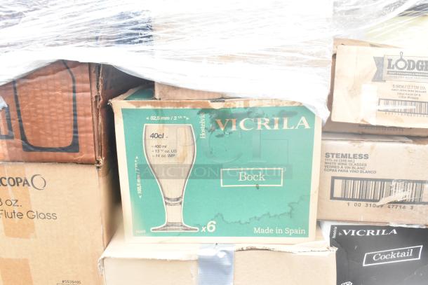 Boxes of Vicrila glassware, including Bock beer glasses, stemless wine glasses, and flute glass boxes, appear slightly worn.