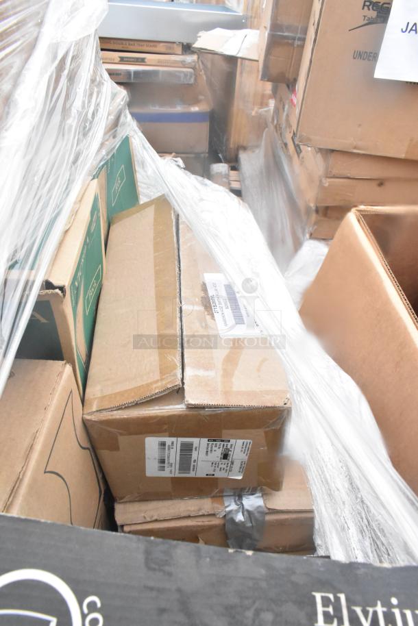 Pallet of boxed items labeled "Scratch and Dent," containing plates, glassware, ramekins; wrapped in plastic.