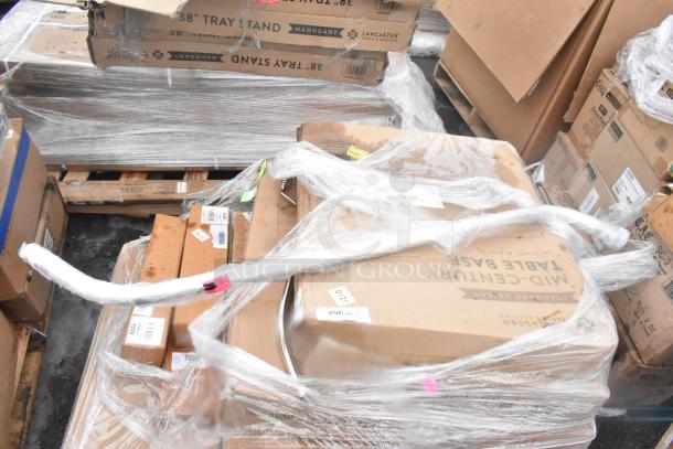 19 new scratch and dent items, including wall corner guards, outdoor tables, and a shelf, wrapped and labeled on pallets.