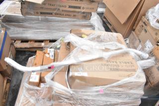 19 new scratch and dent items, including wall corner guards, outdoor tables, and a shelf, wrapped and labeled on pallets.