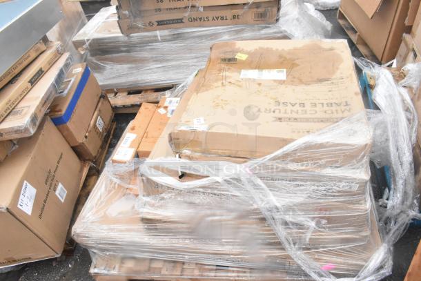 Stack of 19 brand new scratch and dent items, including wall corner guards, outdoor tables, shelf, in wrapped boxes.