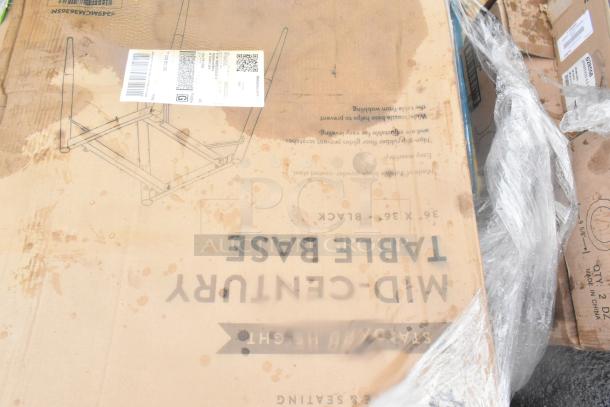 Cardboard box labeled "Mid-Century Table Base" with visible QR code and markings, showing signs of water staining.