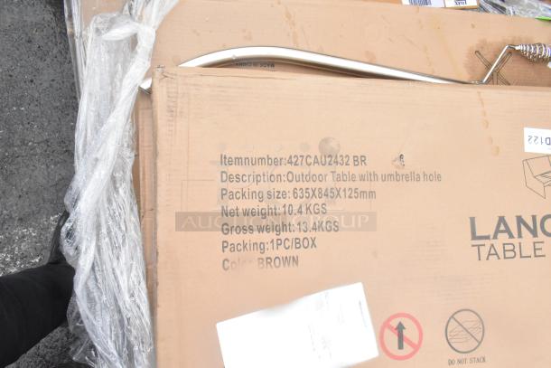 Cardboard box labeled "Outdoor Table with umbrella hole," item number 427CAU2432 BR, color brown. Packing size: 635x845x125mm.