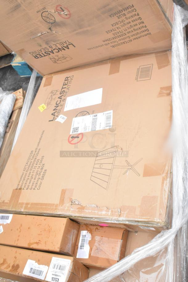 Cardboard boxes containing 19 new scratch and dent items, including wall corner guards, outdoor tables, and a shelf. Visible labels indicate Lancaster brand.