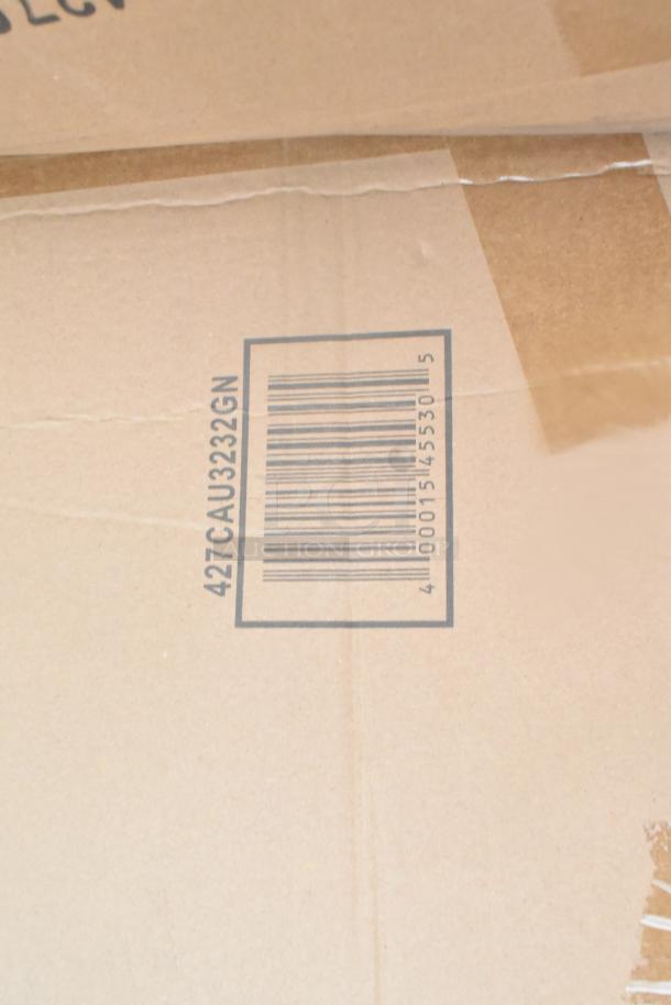 Cardboard box with barcode and text "427CAU3232GN". Contains new scratch and dent items, including wall corner guards and outdoor tables.