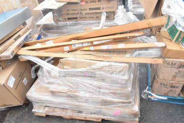 Pallet of 19 scratch and dent items including wall corner guards, outdoor tables, and shelves. Boxes labeled, some partially open.