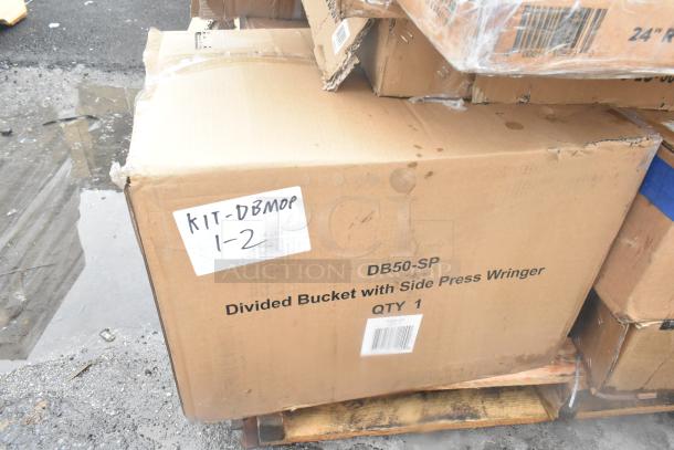 Cardboard box labeled "DB50-SP Divided Bucket with Side Press Wringer, QTY 1" on a pallet, indicating kit contents.