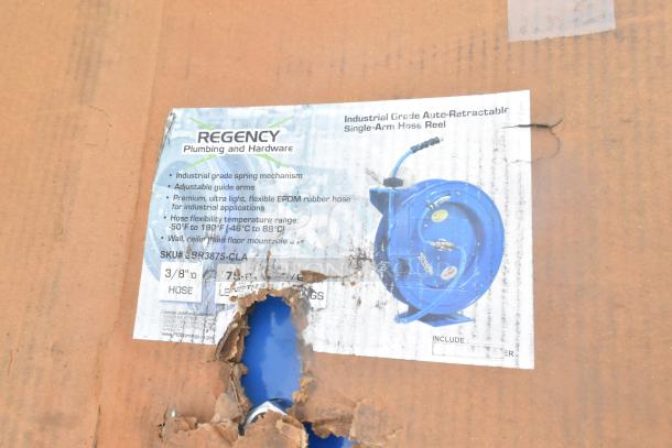 Regency auto-retractable hose reel, industrial grade, 3/8" hose, 75 ft. length. Damaged box, blue reel visible through hole.