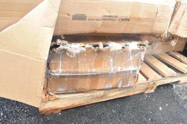 Damaged packaging on pallet containing scratch and dent items: wall corner guard, work table, tray stand. New condition.