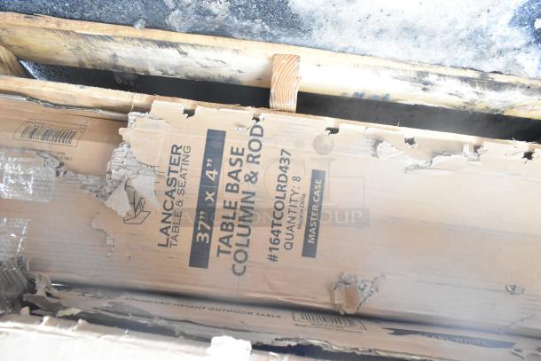 Damaged cardboard box labeled "Lancaster Table & Seating, Table Base Column & Rod, 37'x4'," containing scratch and dent items.