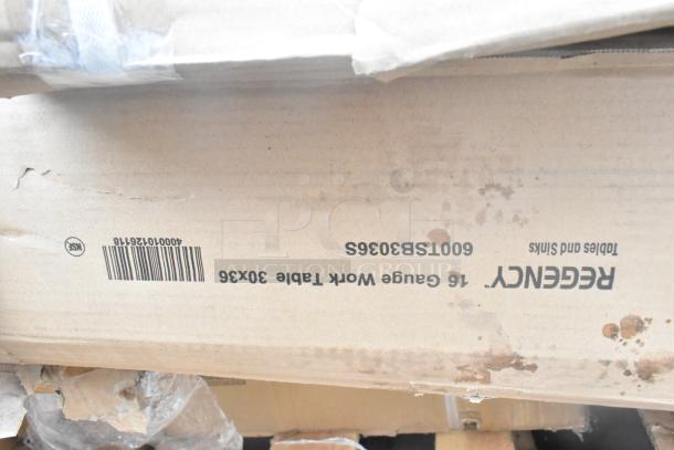 Cardboard box labeled "Regency 16 Gauge Work Table 30x36". Scratch and dent condition. Includes wall corner guard and tray stand.