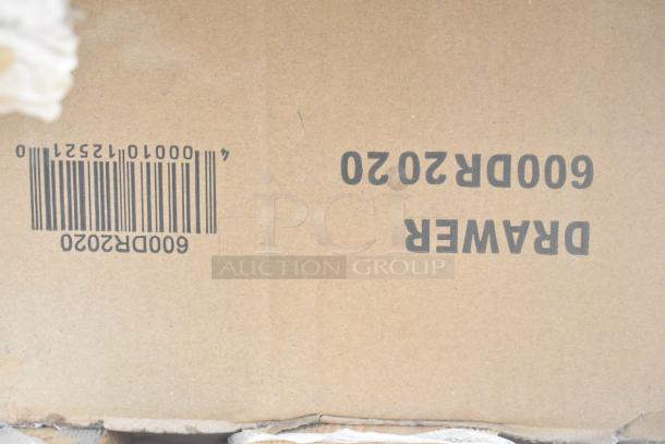 Cardboard box with barcode 000010152520 and label "DRAWER 600 DR2020" for auction of scratch and dent items.