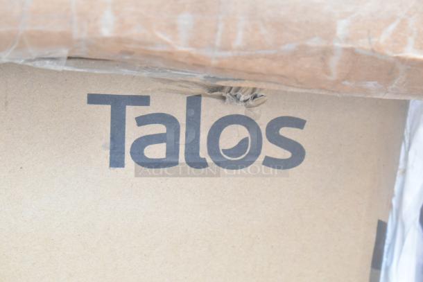 Cardboard box with "Talos" logo, corner slightly damaged. Part of 24 new scratch and dent items like corner guard, table.