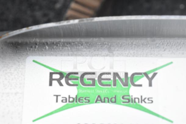 Regency stainless steel mop sink label, showing "Regency Tables and Sinks."