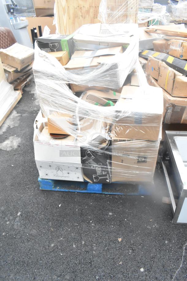 Plastic-wrapped pallet of 34 boxes, including glassware and dishes, labeled with "Champagne" and "Hot Drink Cups." Scratch and dent items.