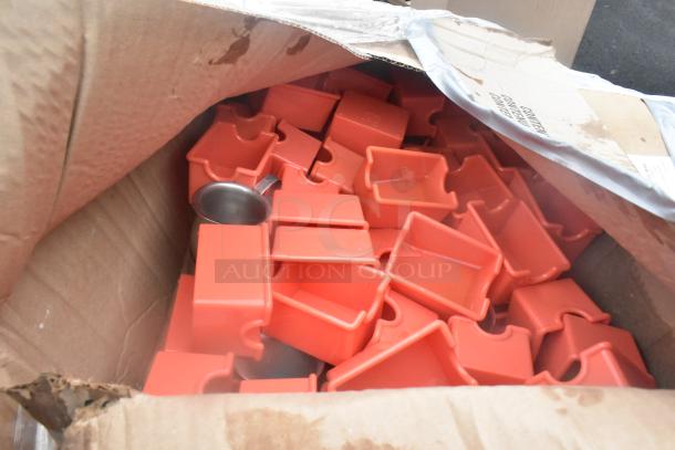 Assortment of red plastic holders in a slightly damaged box, includes a metal scoop; part of a new scratch and dent lot.