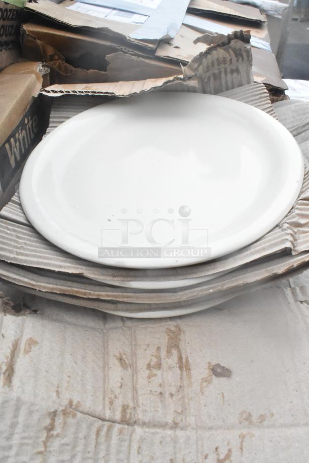 Stack of unboxed white dishes, brand new scratch and dent condition. Packaging shows wear, items appear intact.