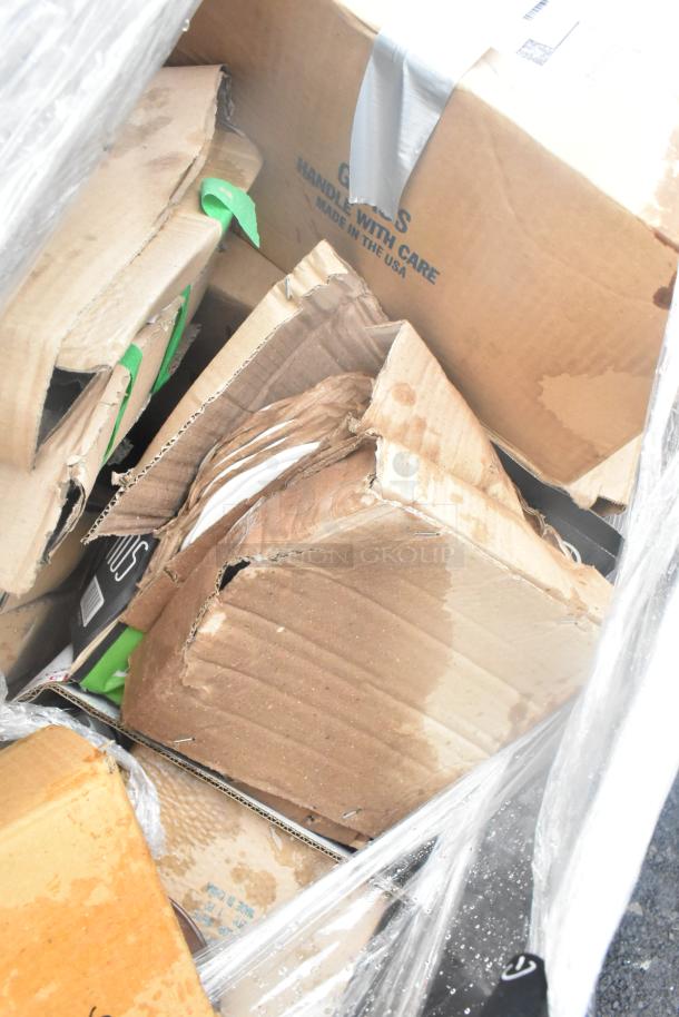 Boxes of glassware and dishes marked "Handle with Care" and "Made in the USA," some with visible water damage.