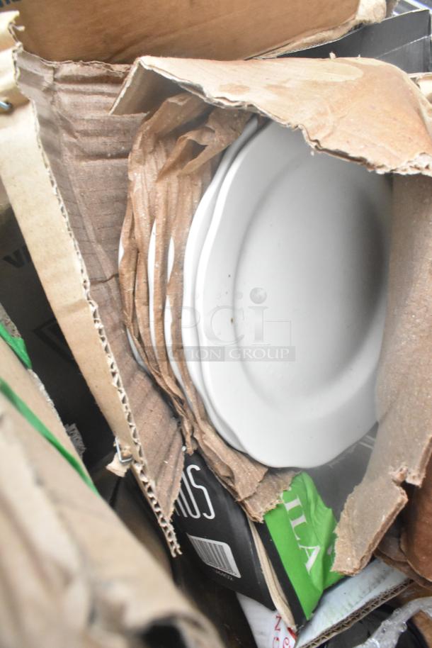 New scratch and dent glassware and dishes packed in boxes, visible signs of packaging wear. 34 items in set.