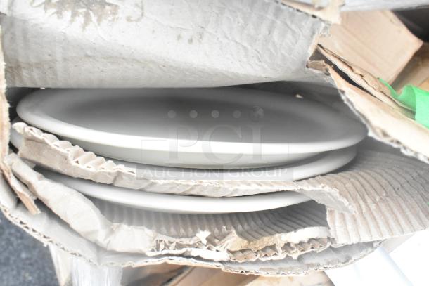 Stack of white dishes in original packaging, slightly damaged box. Part of 34-piece scratch and dent lot, new condition.