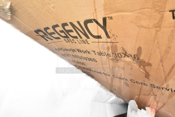 Cardboard box labeled "Regency Spec Line," containing a 14-gauge work table, 30"x36", part number 60TSSB3036S. Box shows wear.