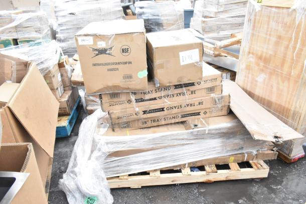 Boxes of 12 new scratch and dent items including wire shelves, dump sink, tray stands, stacked on a pallet.