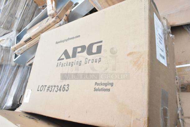 Cardboard box labeled "APG A Packaging Group," LOT #373463, containing wire shelves, dump sink, tray stands. New condition.