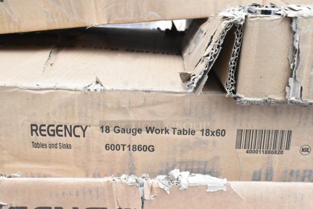 Cardboard boxes labeled "Regency 18 Gauge Work Table 18x60." Slightly damaged packaging. Includes barcode and NSF logo.