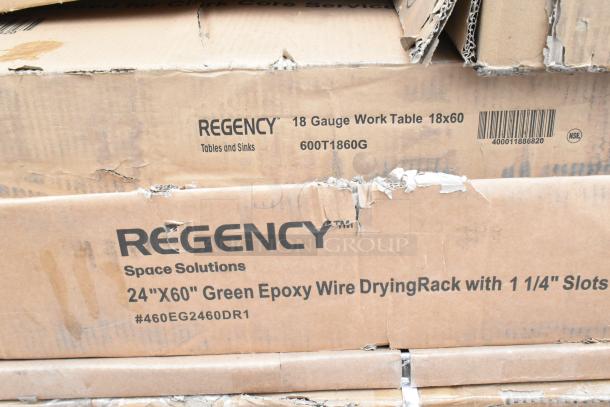 Stack of Regency boxes showing items like an 18x60 work table and 24"x60" green epoxy wire rack. Scratch and dent condition.