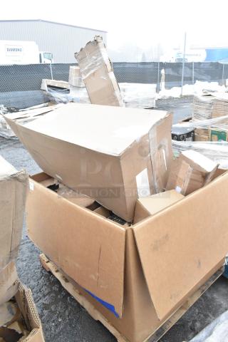 Damaged cardboard boxes on a pallet, containing assorted scratch and dent items like gloves, cart, and ingredient bin.