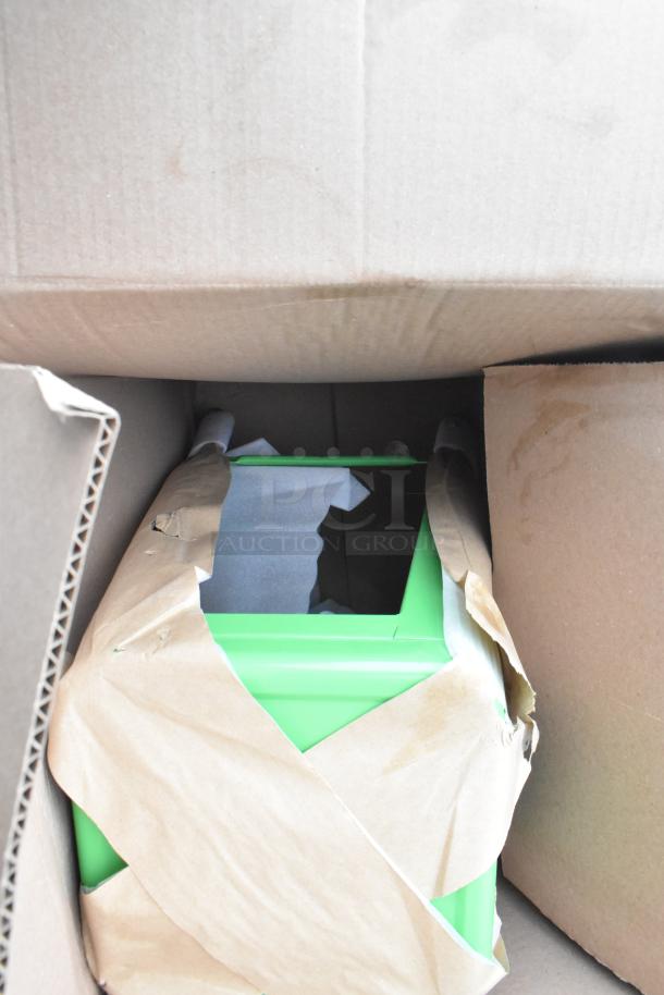Boxed green item partially wrapped in brown paper, possibly part of the scratch and dent auction lot.
