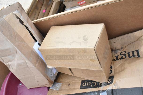 Assorted cardboard boxes showing 8 scratch and dent items, including gloves, cart, and ingredient bin, in varying condition.